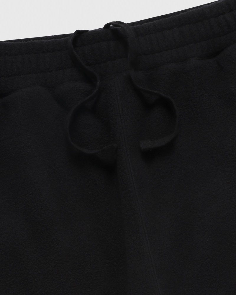 pantaloni della tuta con orlo aperto e logo ovo arch di october neri